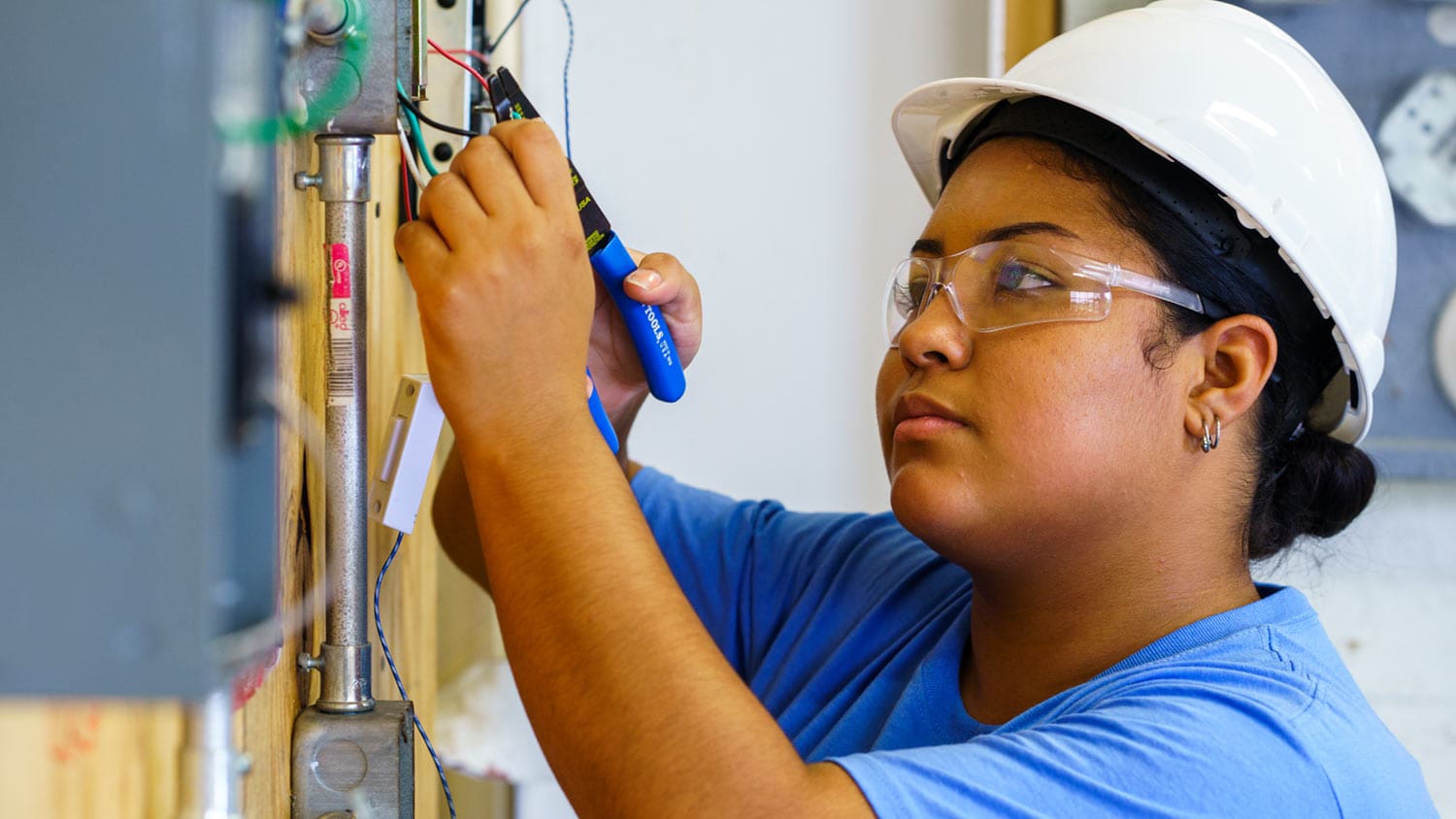 Job Corps student performing electrical work